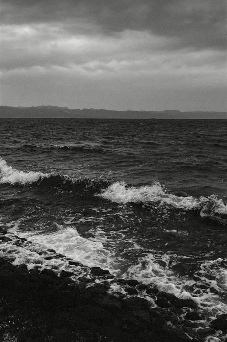 a black and white photo of the ocean