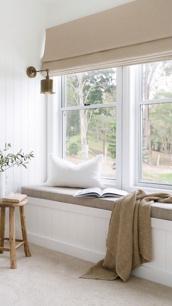 a window seat with a book on it