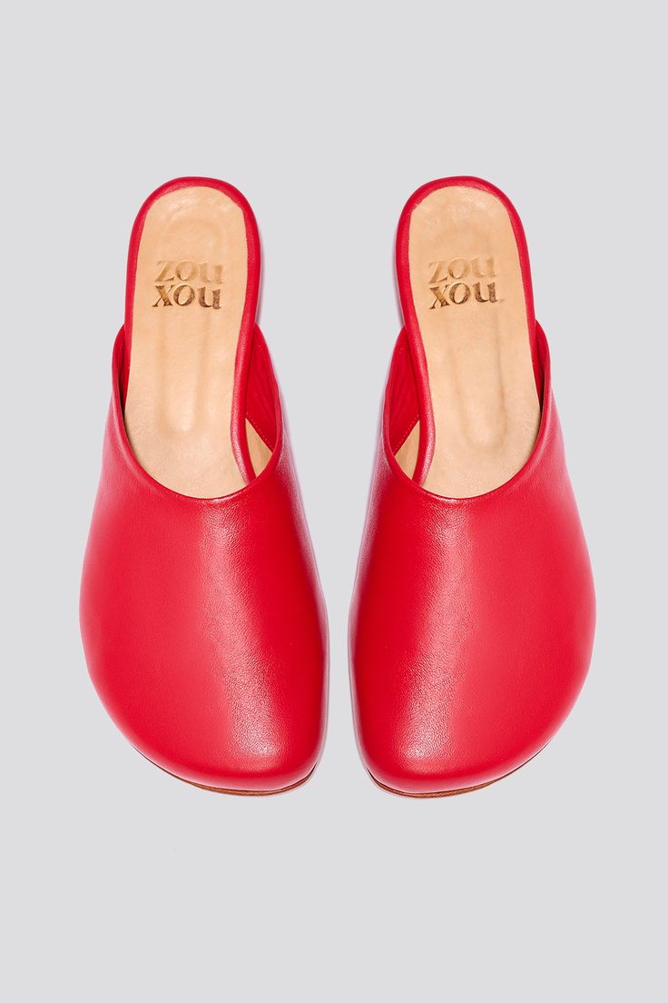 The Charo clog is a slip-on mule featuring a wide toe box and a subtle mini wedge heel. Designed with a touch of irony, this clog is a nod to a familiar comfort shoe but with a refined twist, thanks to its leather sole and a sleek 1-inch heel. Whether styled casually or dressed up, the Charo is a shoe you can rely on to transform your outfit into a look without overthinking it. Made from soft napa leather with a leather lining and leather sole. Handmade in Argentina. Take your usual European siz Slip-on Clogs With Rubber Sole Low Heel, Modern Slip-on Closed Toe Clogs, Slip-on Mules With Low Heel And Rubber Sole, Modern Mules With Wedge Heel And Leather Sole, Modern Slip-on Clogs With Flat Heel, Chic Clogs With Cushioned Footbed And Flat Heel, Low Heel Slip-on Mules With Removable Insole, Slip-on Mules With Rubber Sole And Almond Toe, Comfortable Leather Footbed Mules With Wedge Heel