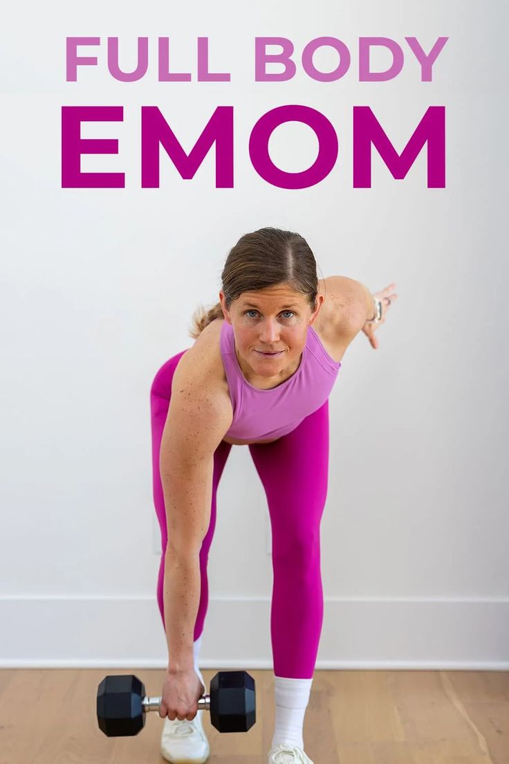 a woman in pink shirt and leggings holding two black dumbbells with the words full body emom above her