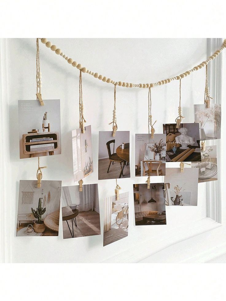 several pictures hanging on a string with gold beads and some photos hung from the wall