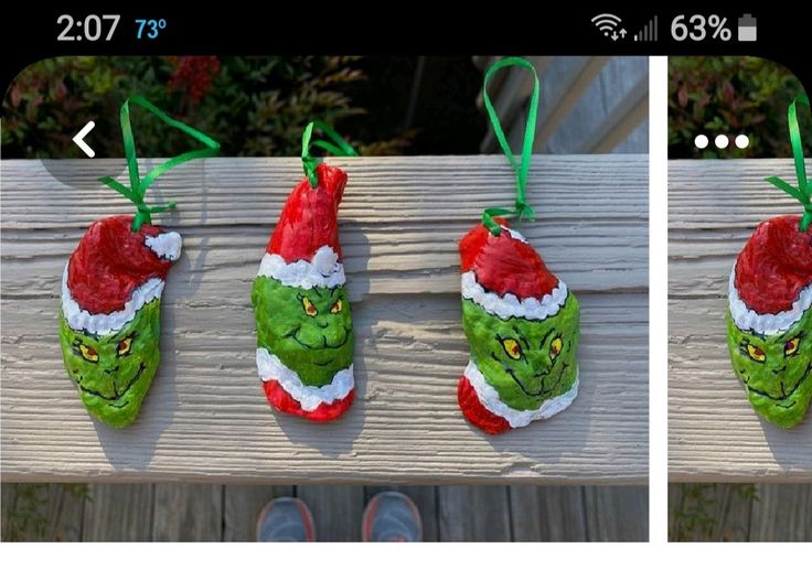 three handmade christmas stockings hanging on a wooden rail with green and red santa hats