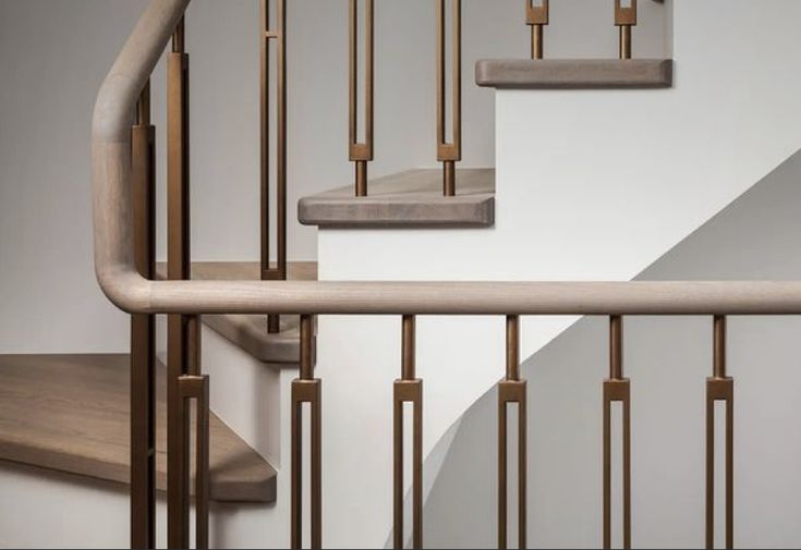 a set of stairs with wooden handrails next to each other