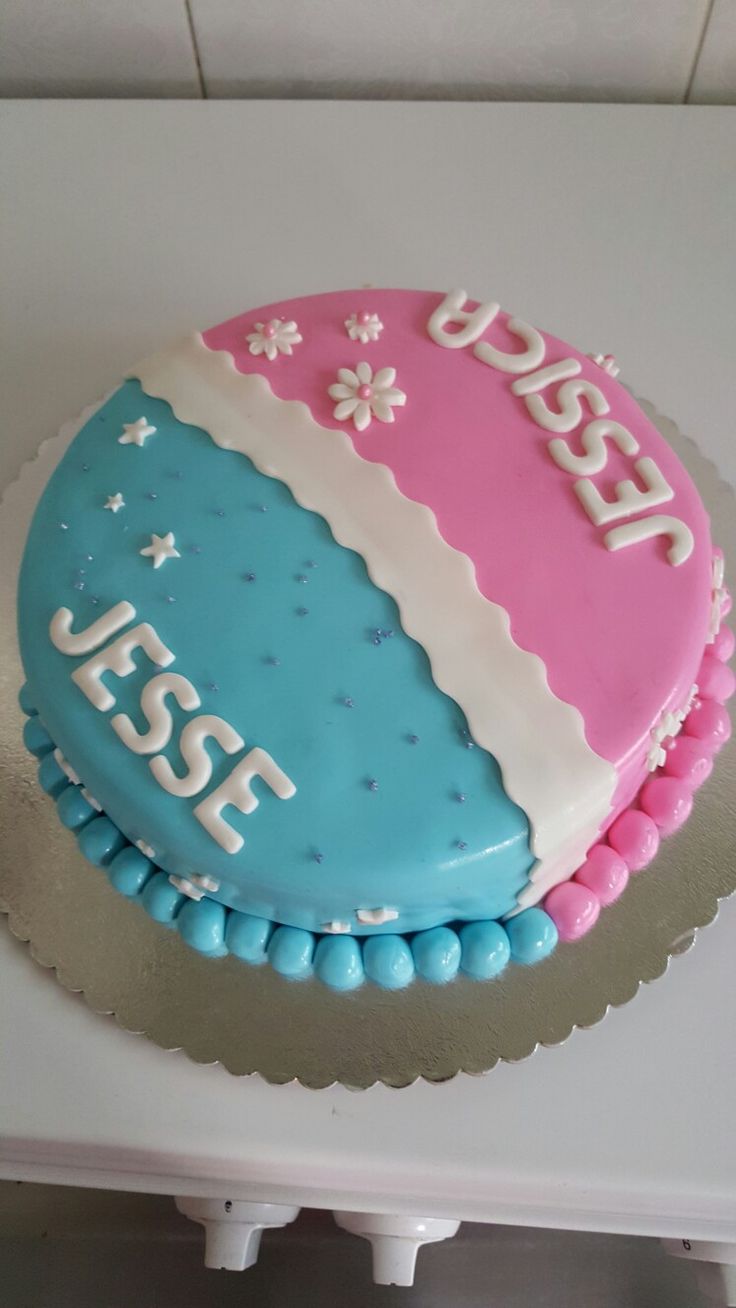 a blue and pink cake with the number 554 on it sitting on a table