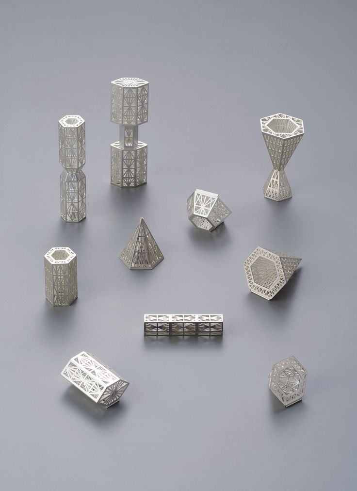 a group of silver objects sitting on top of a gray table next to each other