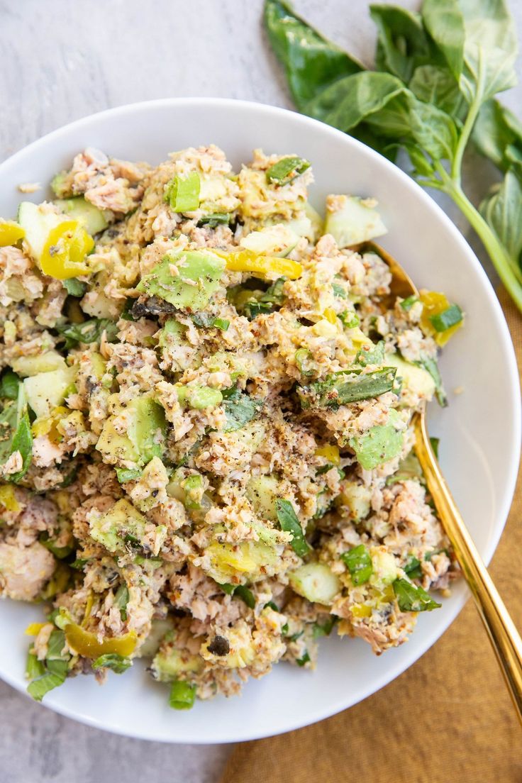 a white bowl filled with meat and vegetables