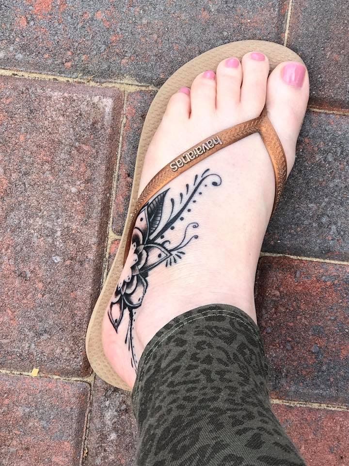 a woman's foot with a tattoo on it