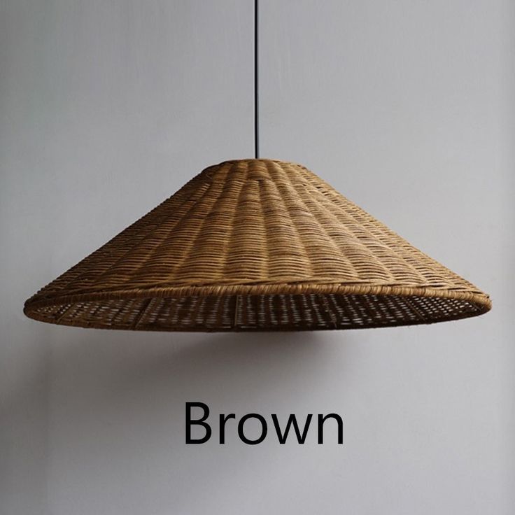 a brown hanging lamp with the word brown on it's side next to a white wall