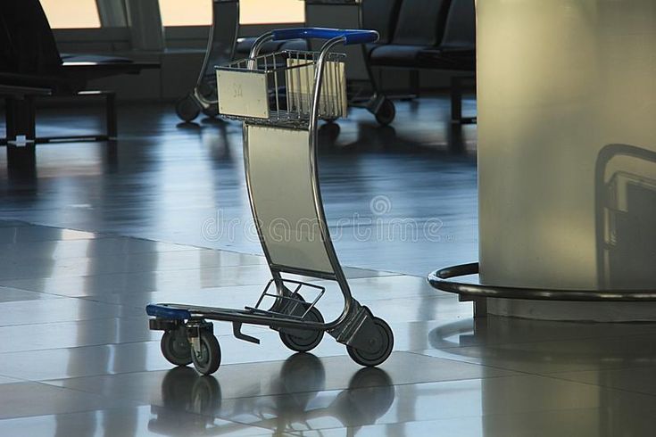 a shopping cart sitting on the floor in an airport royalty images and stock photos for commercial use