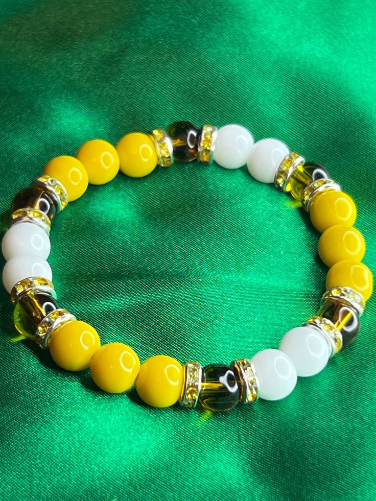 Yellow Honey Bee inspired beaded bracelet with sliver and yellow accents 7.5 in or 19.05 cm Strong, Stretchy, and Durable     Very pretty bracelet for any occasion for any day Blue And Yellow Bracelet, Bee Beaded Bracelet, Yellow Bead Bracelet, Yellow Bracelet, Bee Inspired, Yellow Accents, Bracelet Ideas, Pretty Bracelets, Honey Bee