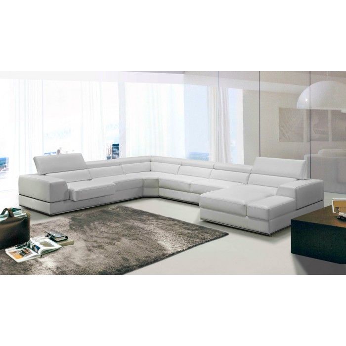 a modern living room with white leather furniture