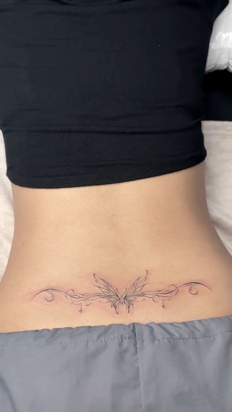 a woman's stomach with a butterfly tattoo on it