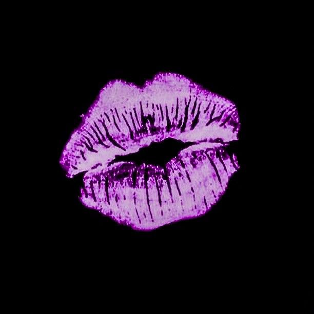 a close up of a purple lipstick on a black background