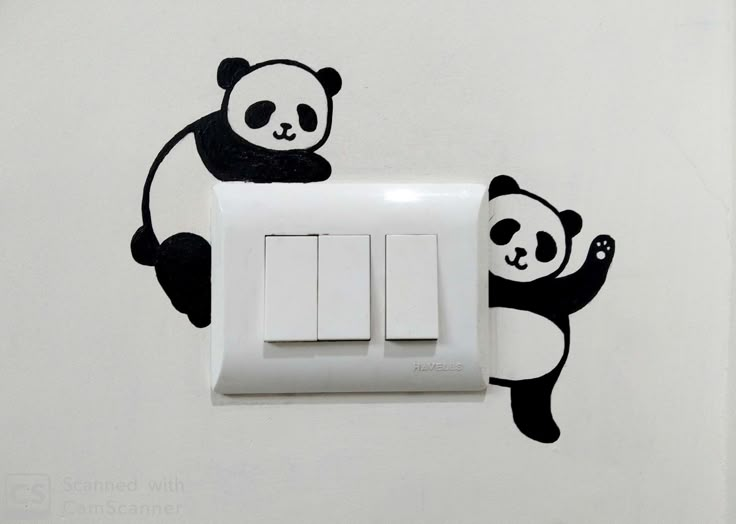 a panda bear sticker is on the wall next to an electrical outlet and light switch