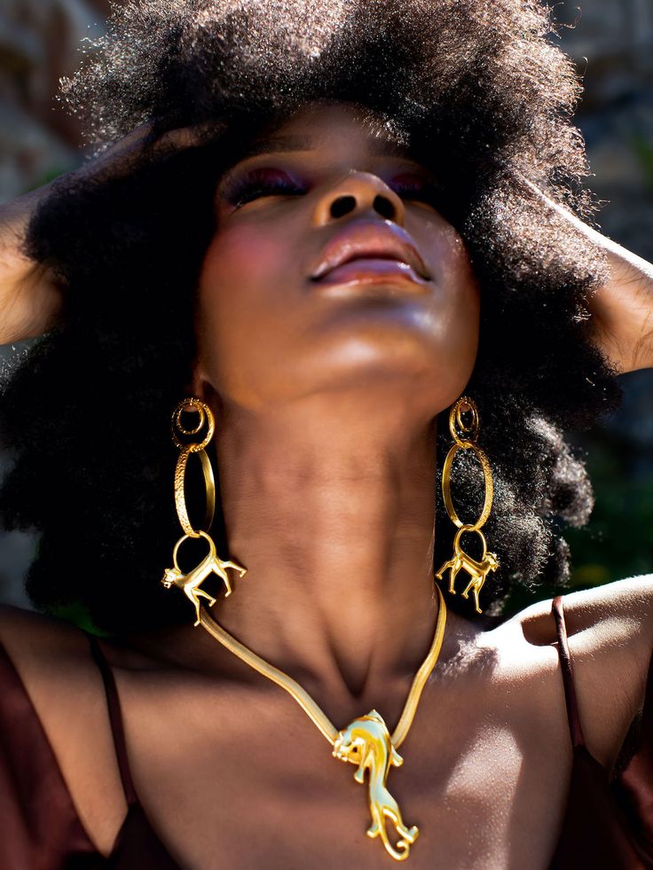 Symbols of Authority say their jewelry is inspired by antiquity, mythology, and ancient monarchies. Putting a modern spin on symbols of African royalty, the Omolola Leopard Necklace has been handcrafted in India using traditional lost wax casting techniques. The stylized leopard hangs from an elegant herringbone chain and is designed to sit just below the collarbone. Wear yours with a scoop-neck top to really keep it in focus. - Lobster clasp fastening - Brass, micron-plated gold - Handcrafted by expert artisans using ethically and sustainably sourced materials - Made in Jaipur, India, ships from Canada Benin Kingdom, Leopard Necklace, African Royalty, Red Carpet Ready, Statement Shoe, Mythology Art, Lost Wax Casting, Dress Crafts, Scoop Neck Top