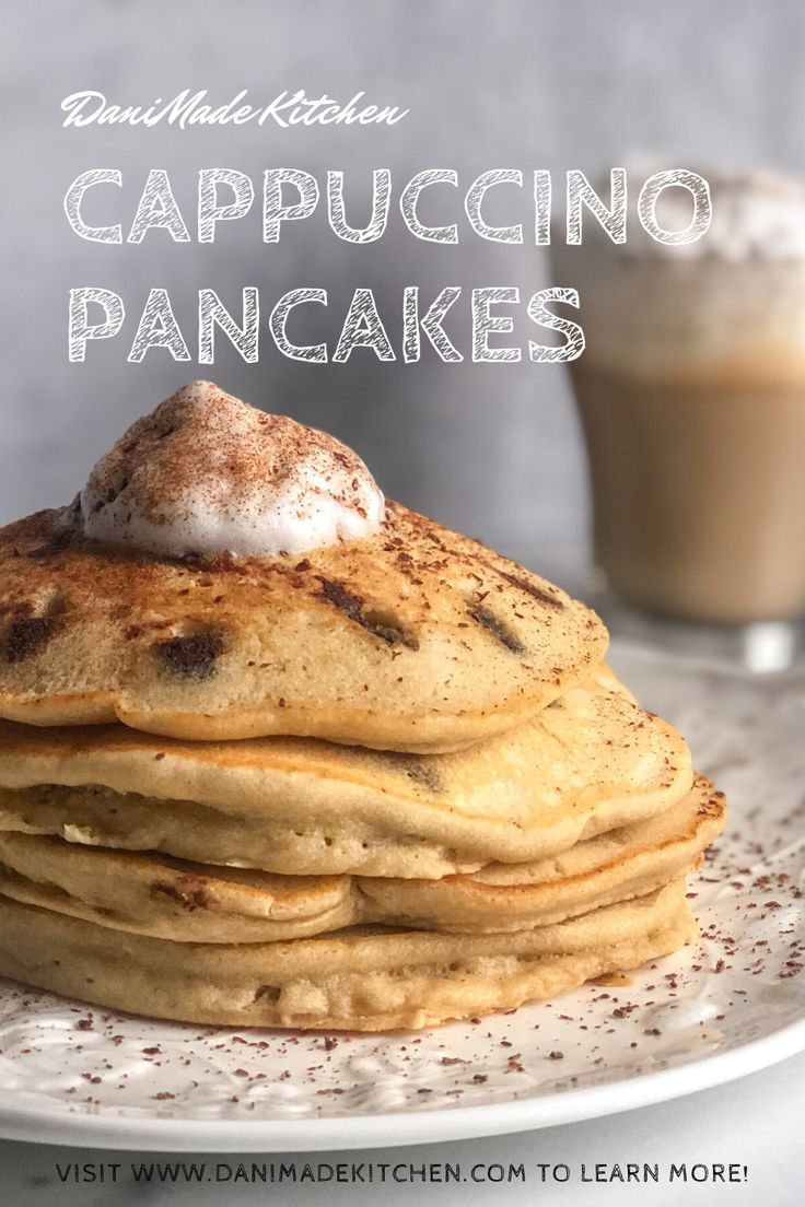 a stack of pancakes with powdered sugar on top and a cup of coffee in the background