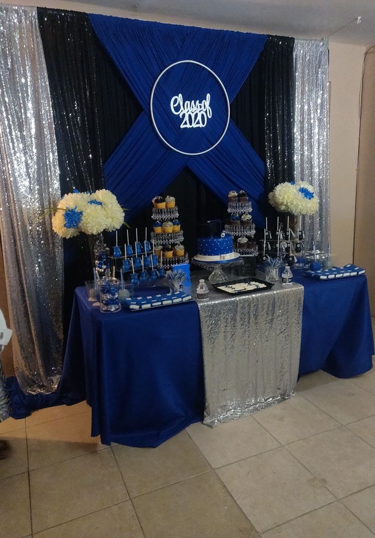 a dessert table with blue and silver decorations