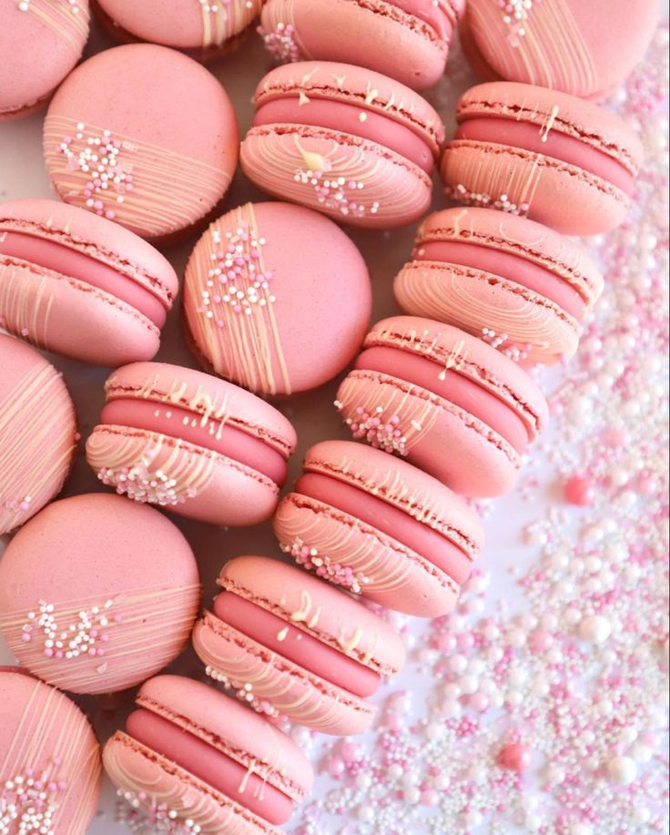 some pink macaroons with white frosting on them