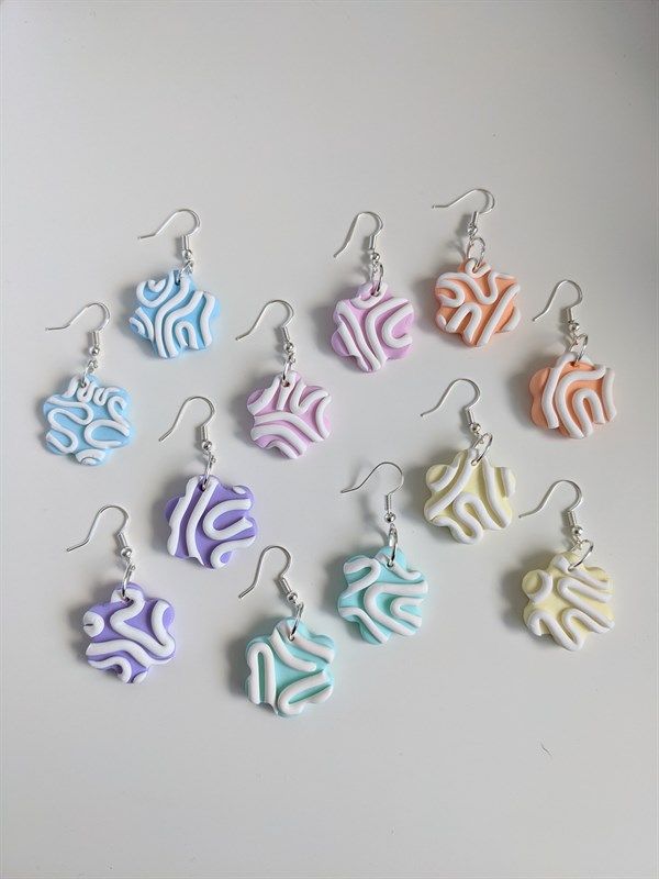 six pairs of earrings with different designs on them