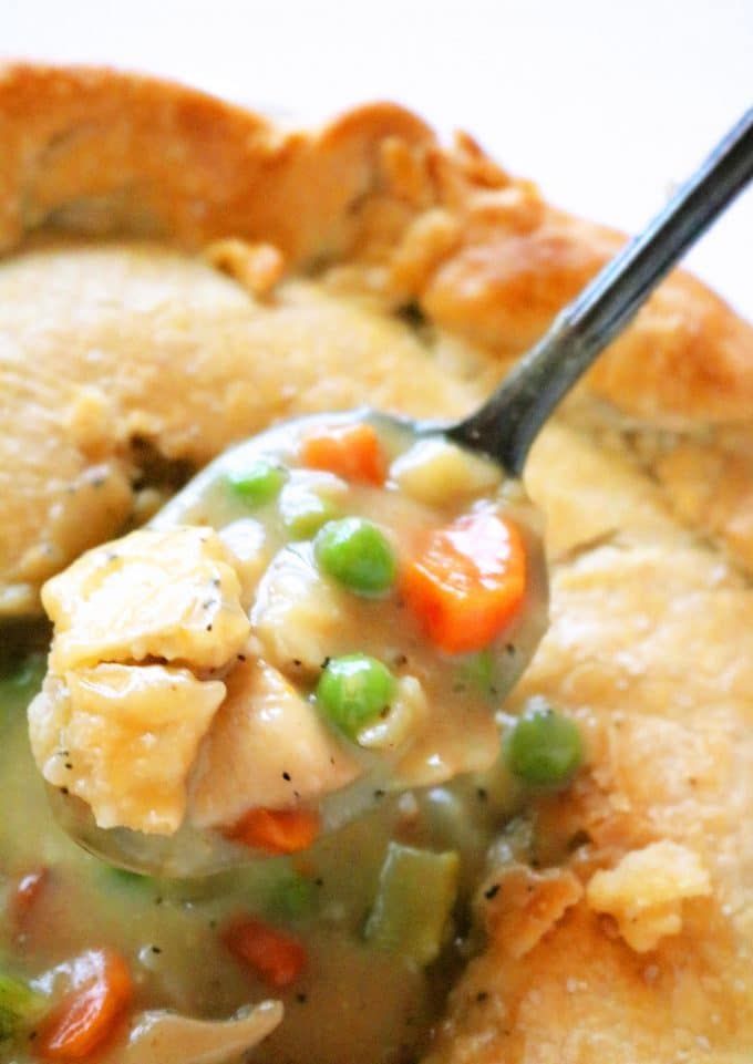 a spoonful of chicken pot pie with peas and carrots