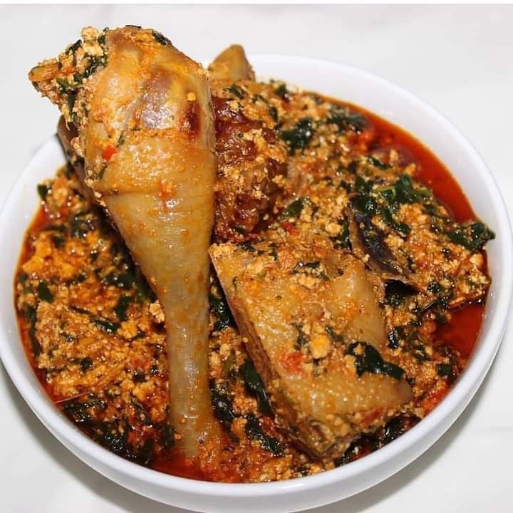 a white bowl filled with food on top of a table