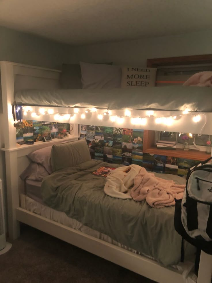 there is a bed that has lights on the headboard and bottom shelf above it