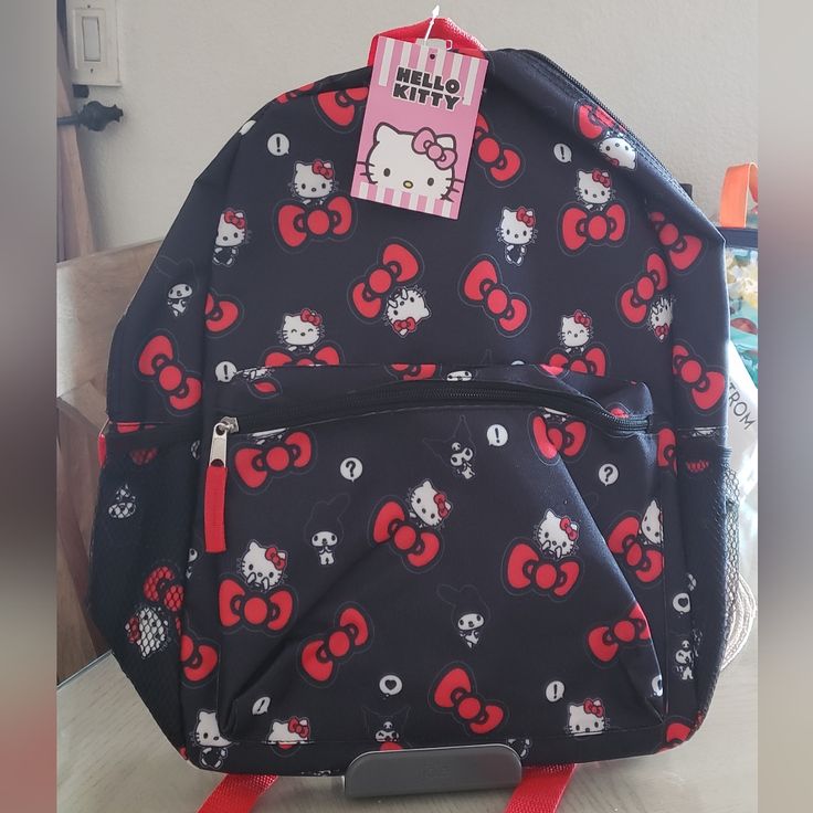 Hello Kitty By Sanrio Backpack 16" X11 1/4" X 4 1/2" Unique Padded Straps With Pattern Of Backpack Unlike Others With Black Or Plain Color Straps Front Large Zip Pocket For On The Go Ez Access Mesh Side Pockets Top Lined With Elastic For Diffrent Size Beverage Containers Pattern Is New For This Year Item Is New With Tag For Additional Savings Bundle Listings Thanks For Looking Cat Design Backpack For End Of School Year, Hello Kitty Rectangular Backpack For Back To School, Hello Kitty Print Travel Backpack, Hello Kitty Travel Bag For Back To School, Hello Kitty Print School Backpack, Black Backpack With Cat Design For Daily Use, Cute Black Backpack For Back To School, Back To School Backpack With Cat Design, Cute Black Backpack For End Of School Year