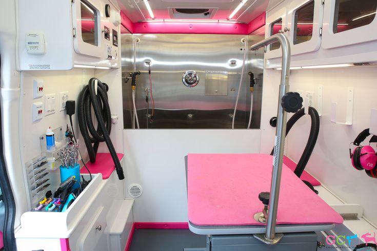 the inside of a vehicle with pink flooring and accessories on it's walls