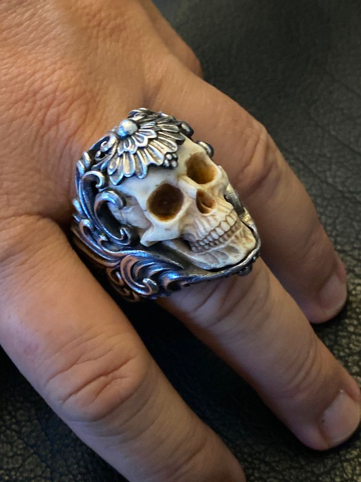 Ring Profile: 🔱This skull ring marks the birth of our studio creations and it truly embodies our flagship craftsmanship and material quality. Each ring is meticulously handcrafted and masterfully finished to ensure that you will receive a piece of wearable art. 🔱The super realistic skull carved from top quality deer antler of high density embedded in an intricate floral ornament silver ring band makes this piece an absolute eye-catcher. The antler skull has been crafted with anatomical correct Floral Armor, Real Human Skull, Realistic Skull, Otherworldly Beauty, Mens Skull Rings, Skull Rings, Exotic Jewelry, Bullet Casing, Skull Lover