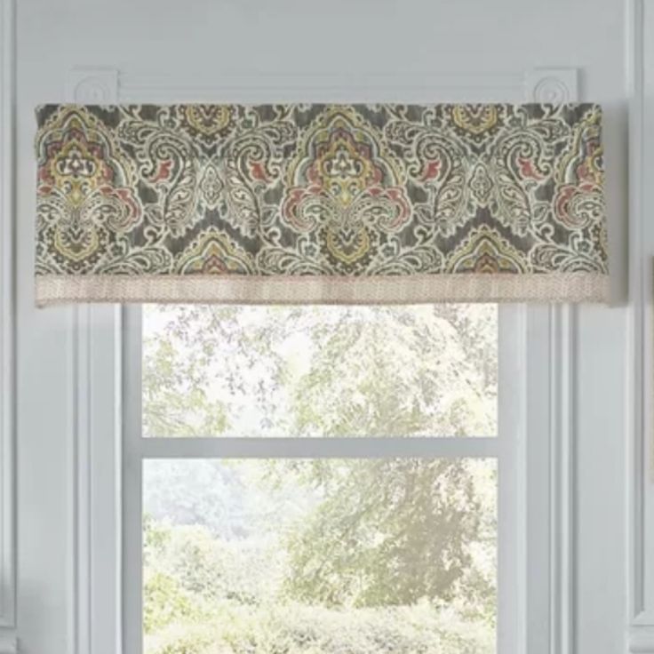 a window with a valance that has an ornate pattern on it