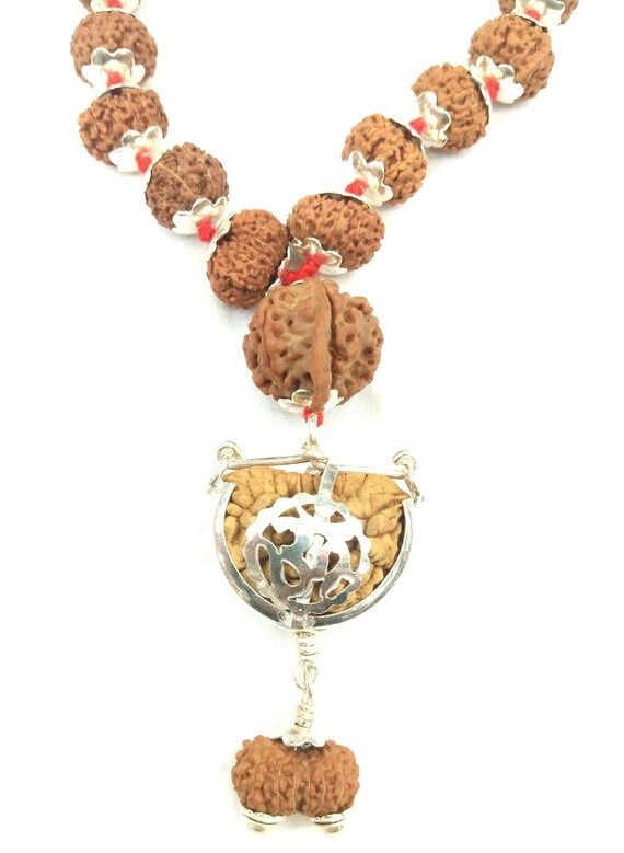 Product Name : Rudraksha Siddha Mala – JavaDesign :  1 till 14 Mukhi Rudraksha , Gauri shankar Rudraksha , Ganesh Rudraksha are fit in silver cap having traditional knots between each beads . And Finally attach the 5 Mukhi rudraksha mala .Total number of Beads : 108 + 1Configration :1 Mukhi Half moon Shape  : 16 mm – 18 mm2 Mukhi  , 3 Mukhi :  7 mm – 8 mm4 Mukhi , 6 Mukhi , 7 Mukhi , 8 Mukhi   : 9 mm – 10 mm9 mukhi , 10 mukhi , 11 mukhi , 12 mukhi , 13 mukhi , 14 mukhi : 13 mm – 14 mmGauri shank Multicolor Mala For Puja And Festive Occasions, Festive Spiritual Mala With Tilla, Traditional Multicolor Mala For Puja, Traditional Silver Mala For Meditation, Navratri Puja Mala With Latkans, Mala With Latkans For Navratri Puja, Spiritual Mala For Rituals And Festivals, Spiritual Festive Mala With Latkans, Spiritual Mala With Latkans For Festive Occasions