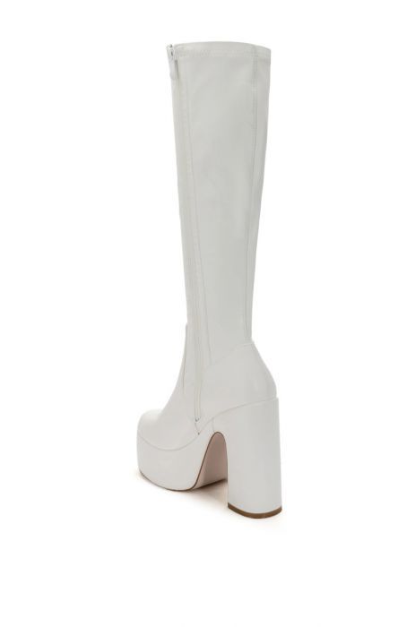 **FINAL SALE - NO EXCHANGES OR RETURNS** Like go go boots but even cuter! The Sutton PU Chunky Boot In White is made from a Faux leather upper and features a knee-high shaft, an almond toe silhouette, a chunky heel, and a platform sole. Complete with an inner ankle zipper closure. Style these with a fun, flowy dress to get a retro look! Fit and details (approx. measured from a women’s size 7.5) Faux leather upper Almond toe Chunky heel Platform sole 17.5” shaft height 5.5” heel height 2” platfor White Knee-high Boots With Round Toe For Winter, Fitted White Platform Boots For Fall, White Knee-high Medium Width Heeled Boots, White Knee-high Boots Medium Width, Trendy White Knee-high Heeled Boots, Trendy White Knee-high Boots, White Knee-high Boots For Spring, White High Ankle Knee-high Boots For Fall, White Knee-high Boots For Fall