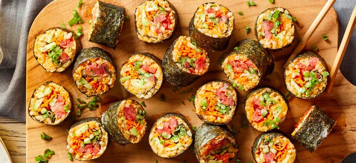 sushi rolls on a wooden board with chopsticks