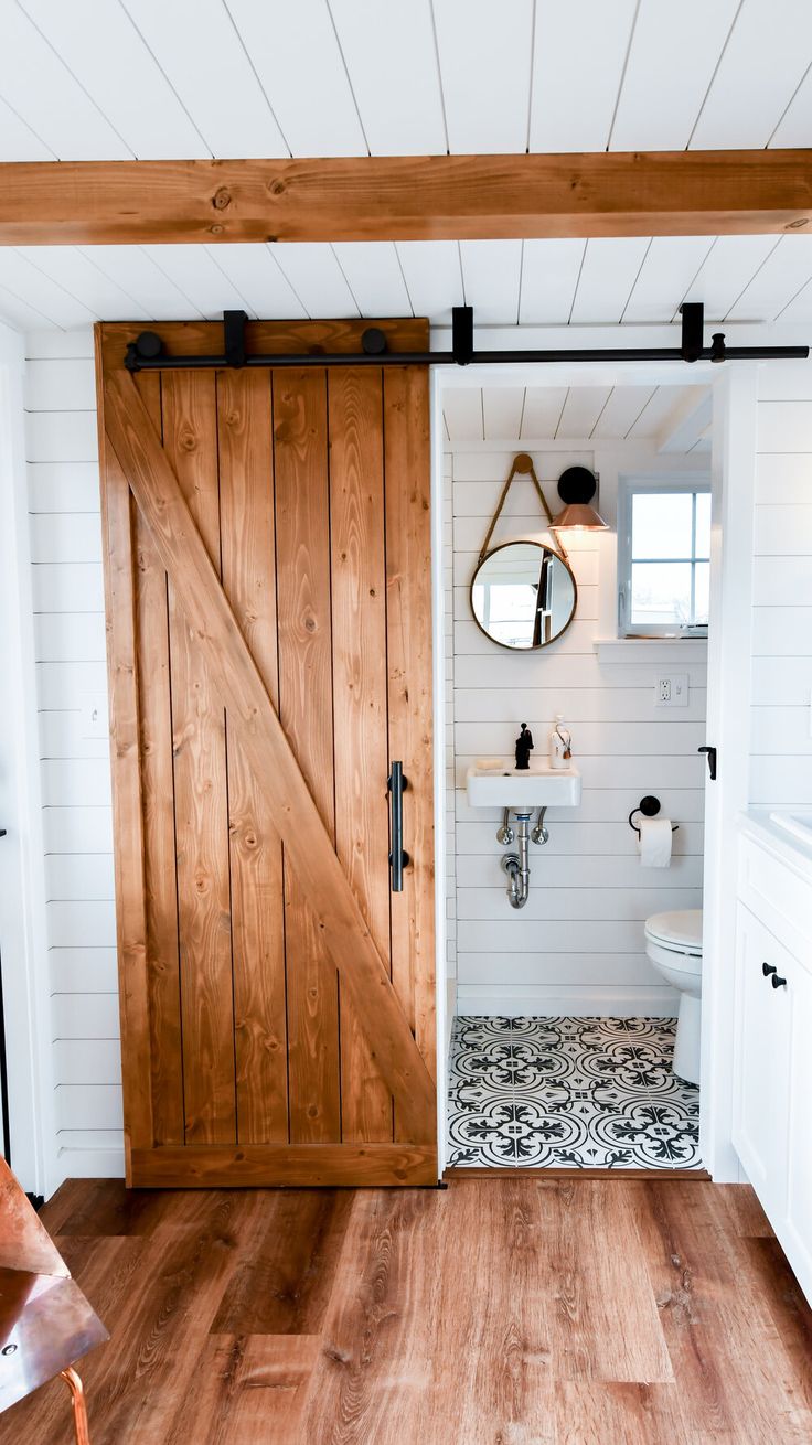 a bathroom with wooden doors and white walls