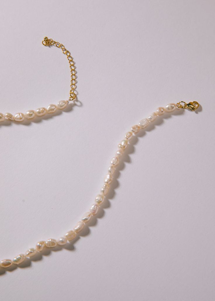 Pearl Strand Elegant Pearl Shell Necklace With Round Beads, Single Strand Pearl White Necklace, Single Strand Pearl White Pearl Necklace, White Pearl Choker With Adjustable Chain, Elegant Beaded Pearl Shell Necklace, Elegant Adjustable Mother Of Pearl Necklace, Pearl White Shell Necklace With Pearl Chain, Pearl White Single Strand Choker Necklace, Adjustable Pearl Choker Necklace