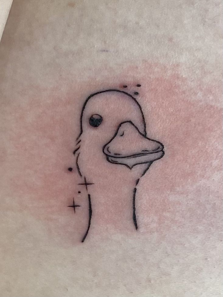 a close up of a tattoo on the back of a person's stomach with a duck