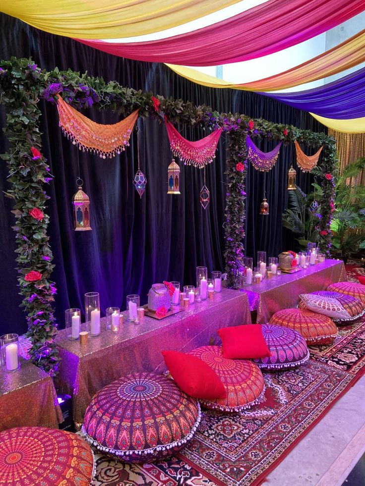 an elaborately decorated banquet table with pink and purple decor