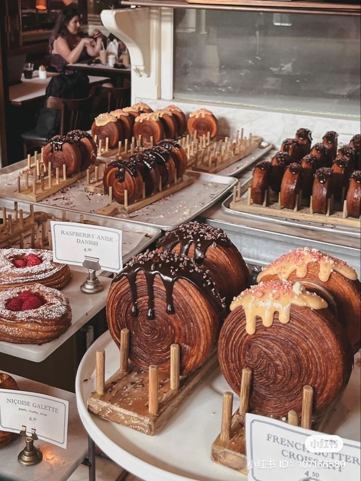 desserts and pastries on display in a bakery