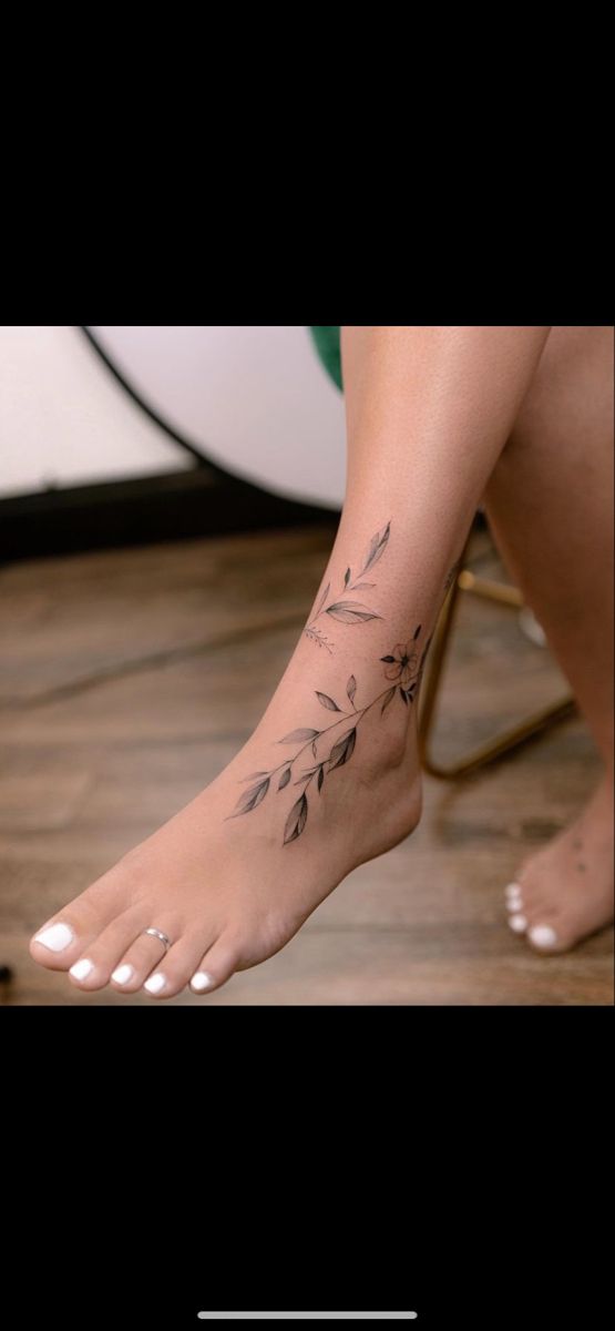 a woman's foot with a tattoo on it