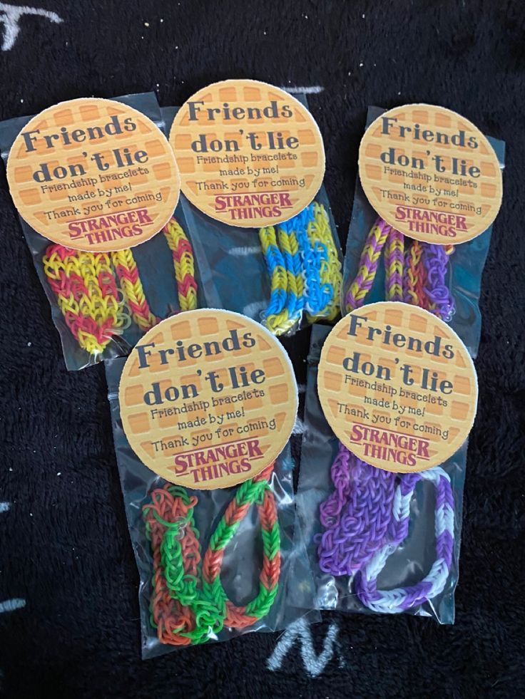 four friends don't lie bracelets are packaged in cellophane bags on a black surface