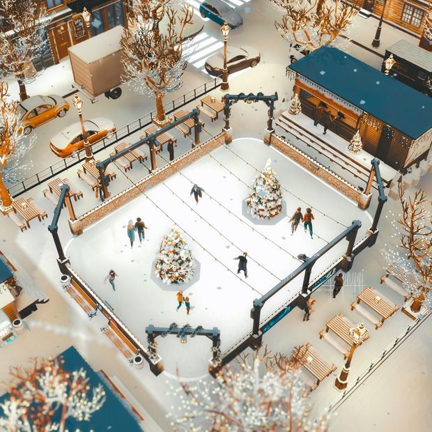 an aerial view of a wintery town with people skating on the rink and snow covered trees