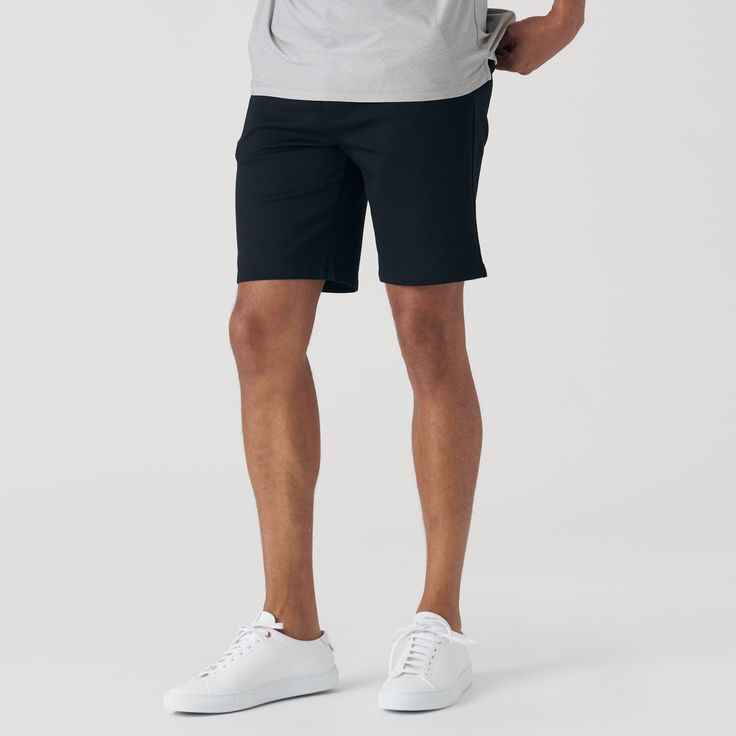 Features: Premium fitted extra soft, ultra stretch chino shorts 9.5 inch inseam length Perfect combination of comfort and durability for everyday wear 69% Rayon/26% Nylon/5% Spandex Side entry pockets and two back pockets with button closure Fabric will shrink minimally (5%) on a low heat setting in the dryer Fit: This is a modern classic cut. Colors Included in Pack: Black Chino Shorts Navy Chino Shorts Care Instructions: Machine Wash Cold, No Bleach Tumble dry low, Cool Iron. Okay to dry clean Athleisure Cotton Shorts With 4-way Stretch, Classic Black Shorts For Business Casual, Navy Casual Elastane Bottoms, Fitted Black Cotton Bermuda Shorts, Classic Black Business Casual Shorts, 4-way Stretch Cotton Shorts, Solid Cotton 4-way Stretch Shorts, Cotton 4-way Stretch Shorts, Casual Fitted Bermuda Shorts For Work