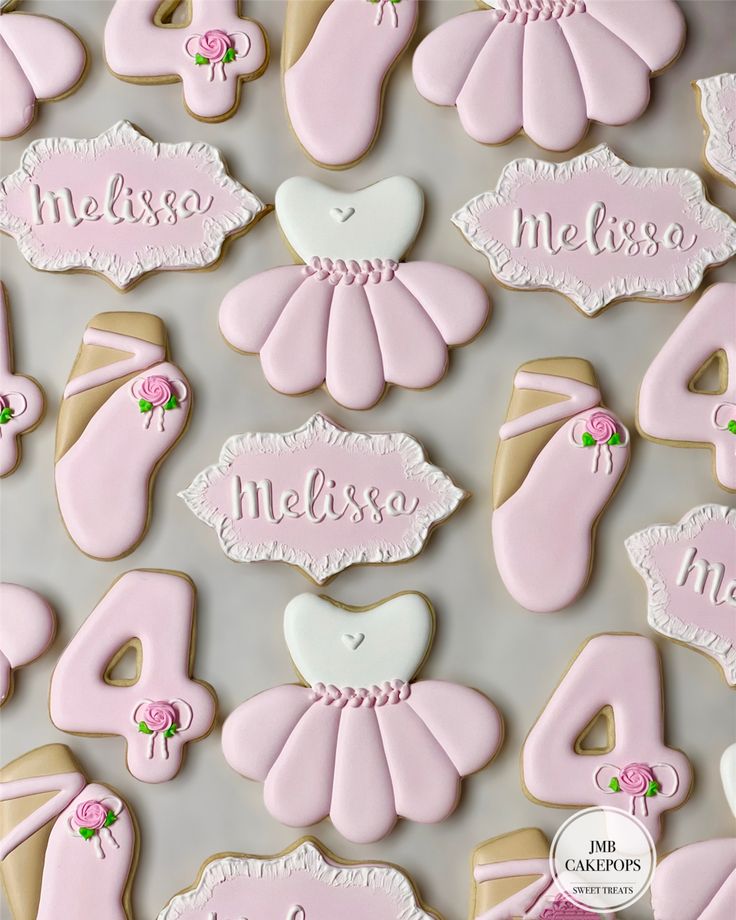 decorated cookies with pink and white icing on a table