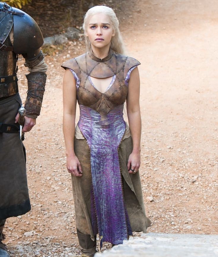 the game of thrones character is standing next to a man with white hair and wearing armor