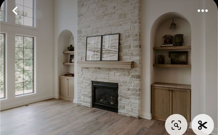 an empty living room with white brick fireplace