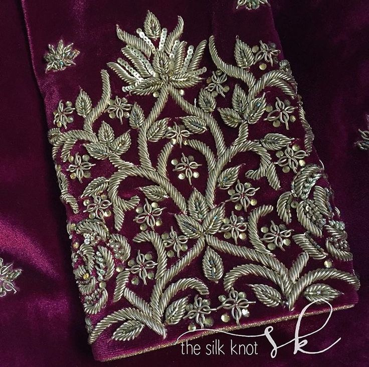 an embroidered purple fabric with gold thread work