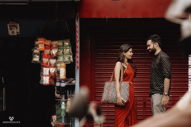 a man and woman standing in front of a store