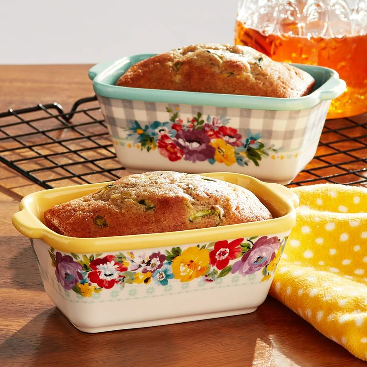 three dishes with food in them sitting on a table next to a cooling rack and honey