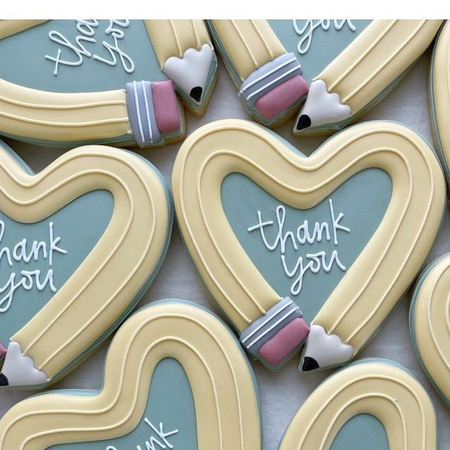 decorated cookies in the shape of hearts with thank you written on them are displayed together