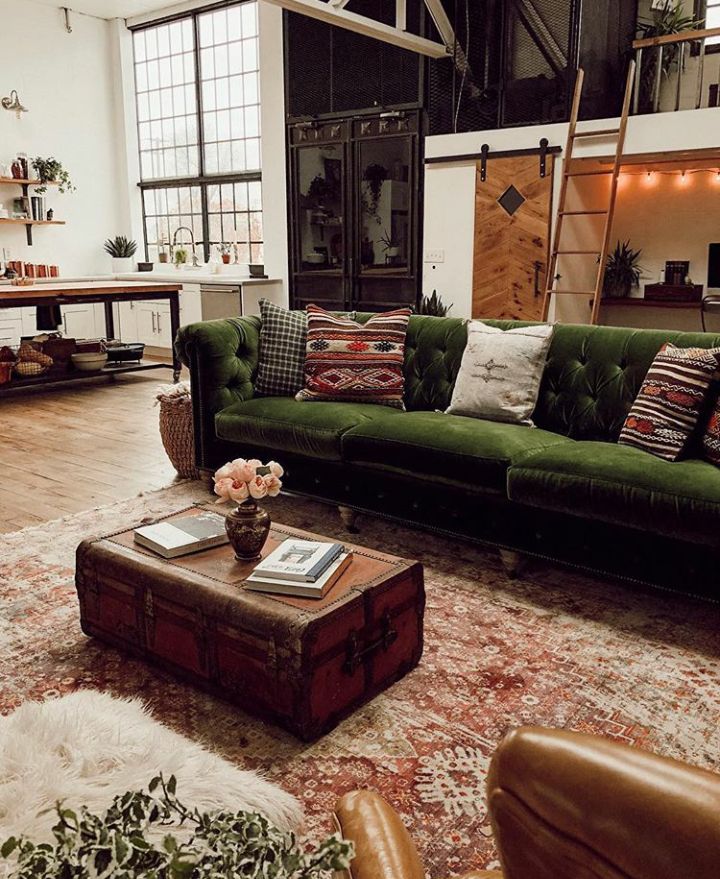 a living room filled with furniture and lots of windows